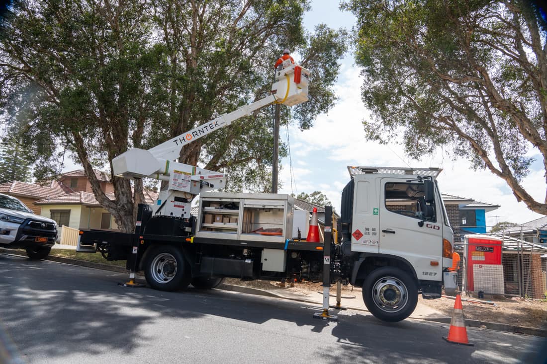 Branded Thorntek truck with elevated work platform on a Sydney street