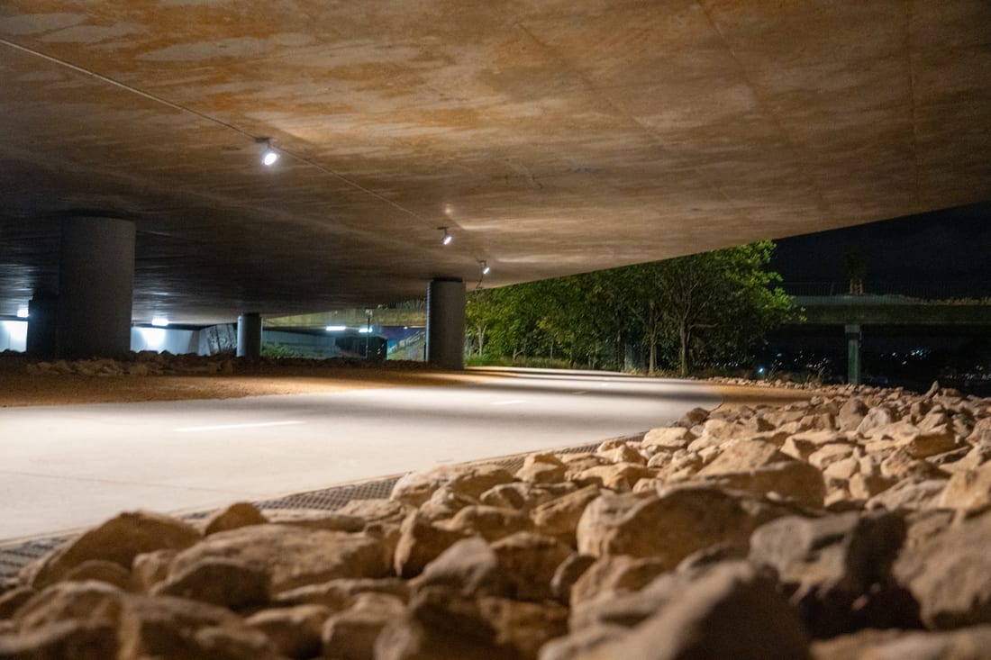 Shared pathway lighting installed by Thorntek under a Sydney bridge, photographed at dusk