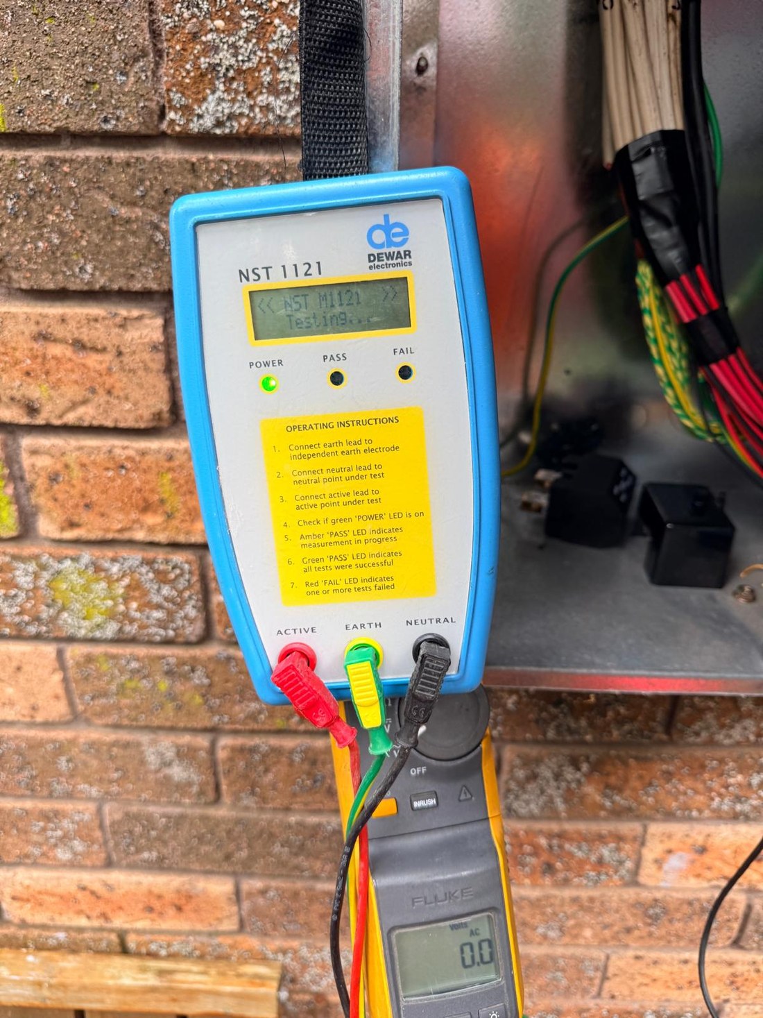Thorntek running an electrical test on a switchboard with a neutral integrity tester and clamp meter