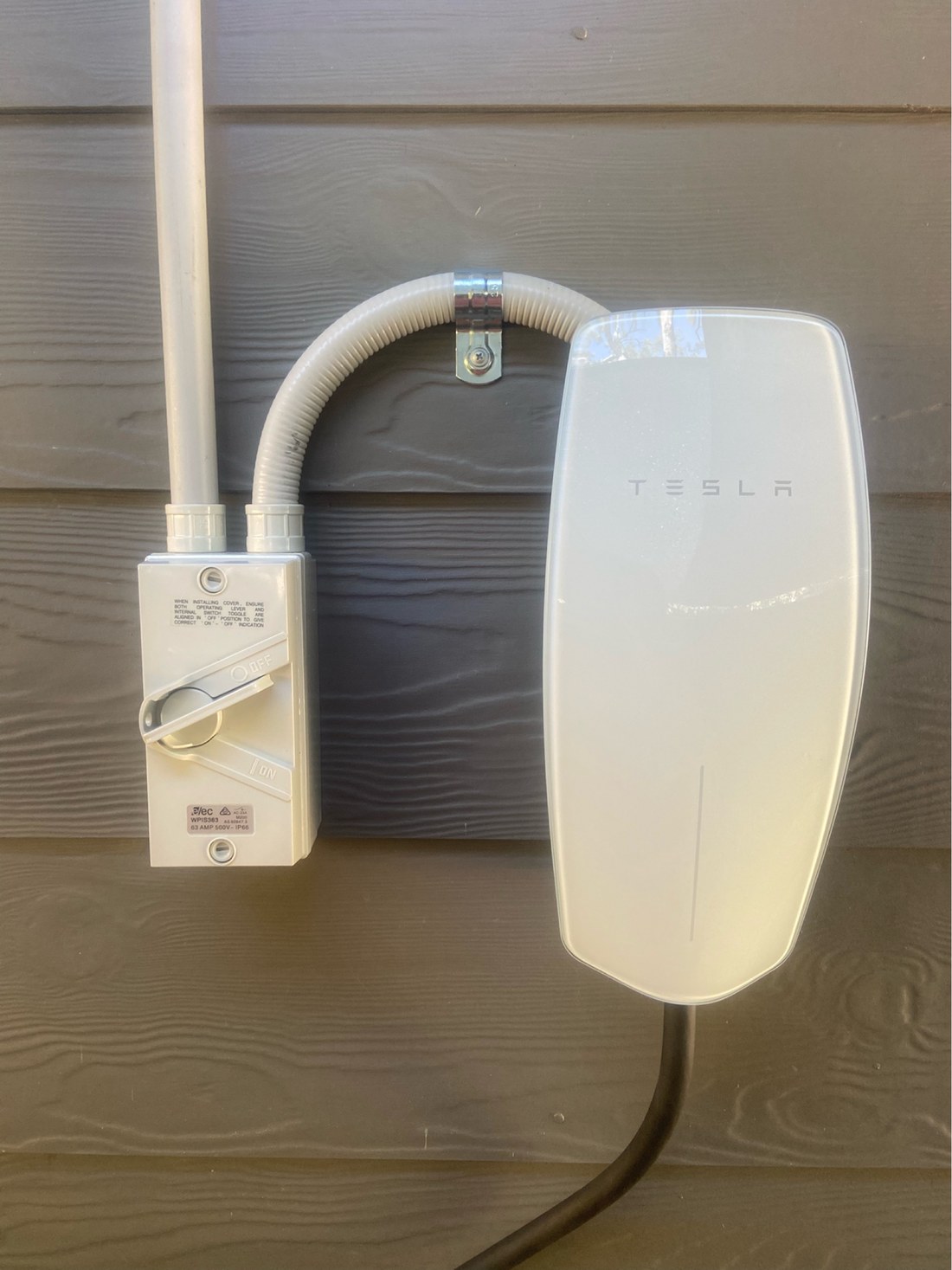 Tesla wall charger installed by Thorntek with a weatherproof isolator