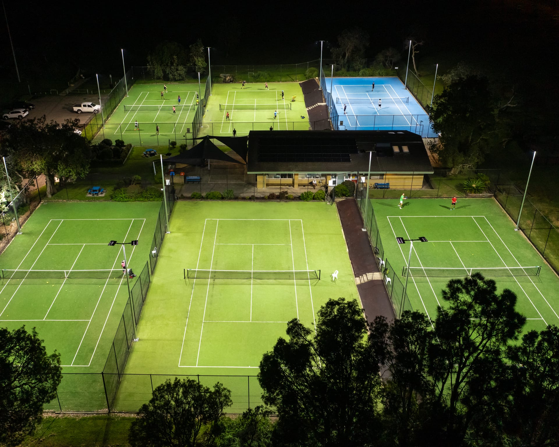 Floodlit tennis courts at Collaroy at night, aerial view